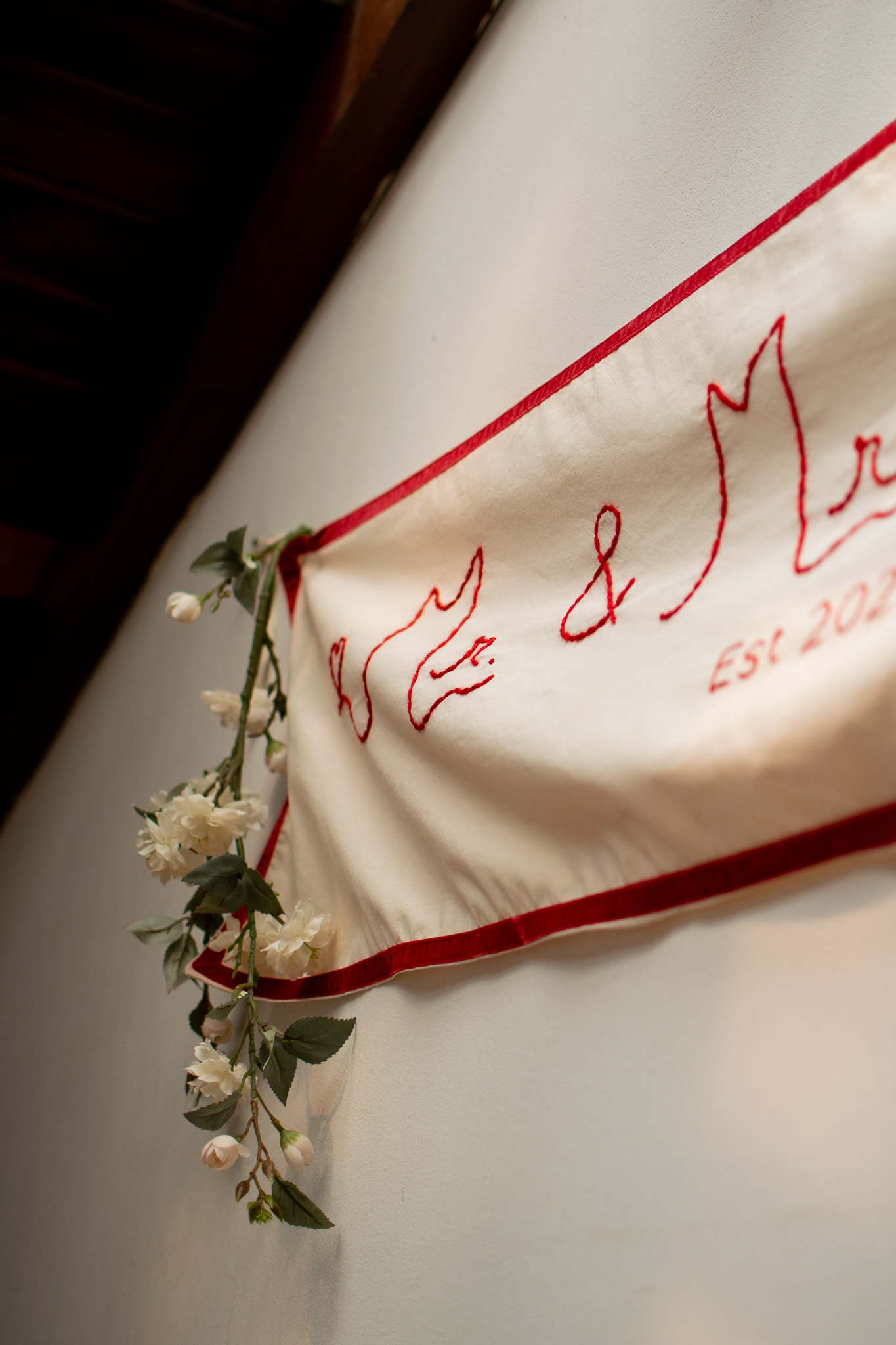 Hand-embroidered baby milestone blanket with delicate floral frame
