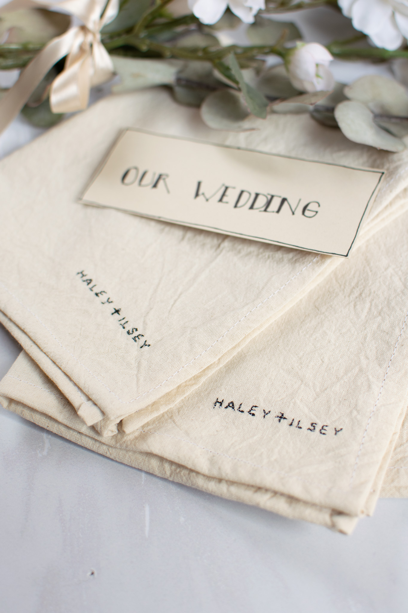 Birth announcement embroidered hoop with baby name and floral wreath